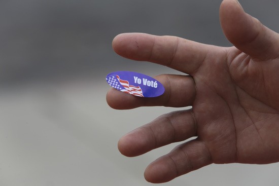 A California primary voter shows the Spanish language I Voted sticker outside a polling station June 7, 2016 in San Diego, California.  / AFP / Bill Wechter        (Photo credit should read BILL WECHTER/AFP via Getty Images)