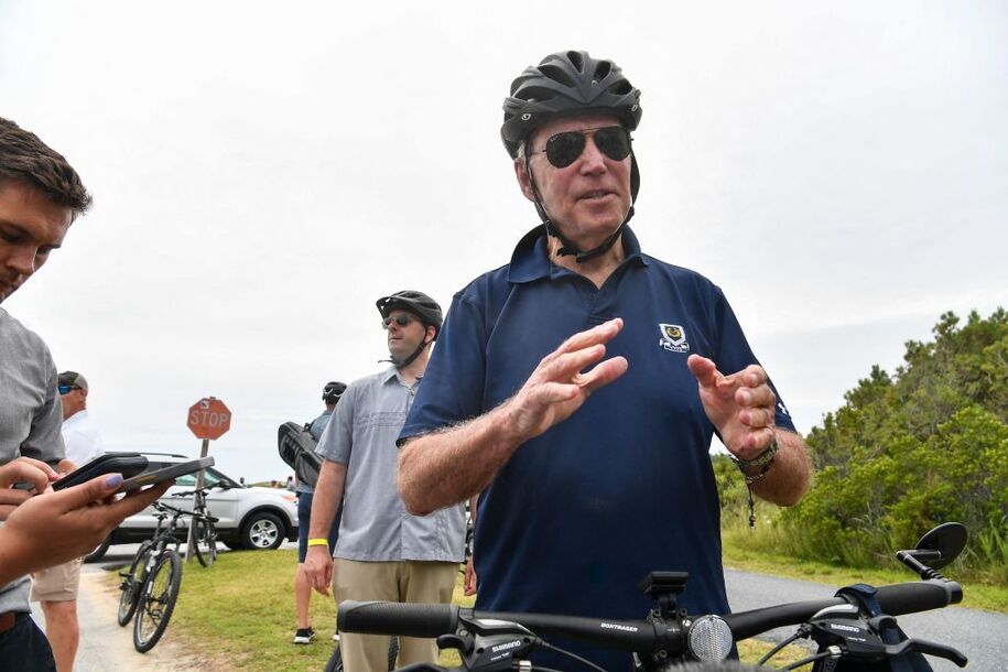 US President Joe Biden stops to talk to reporters during a bike ride in Gordon's Pond State Park in Rehoboth Beach, Delaware on July 10, 2022. (Photo by Nicholas Kamm / AFP) / The erroneous mention[s] appearing in the metadata of this photo by Nicholas Kamm has been modified in AFP systems in the following manner: [Rehoboth Beach] instead of [Rehobeth Beach]. Please immediately remove the erroneous mention[s] from all your online services and delete it (them) from your servers. If you have been authorized by AFP to distribute it (them) to third parties, please ensure that the same actions are carried out by them. Failure to promptly comply with these instructions will entail liability on your part for any continued or post notification usage. Therefore we thank you very much for all your attention and prompt action. We are sorry for the inconvenience this notification may cause and remain at your disposal for any further information you may require. (Photo by NICHOLAS KAMM/AFP via Getty Images)