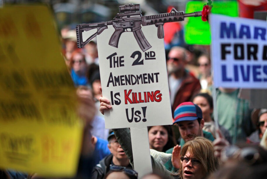 Protestors hold signs during a 'March For Our Lives' demonstration demanding gun control in Sacramento, California, U.S. March 24, 2018.  REUTERS/Bob Strong - RC1897A3DCC0