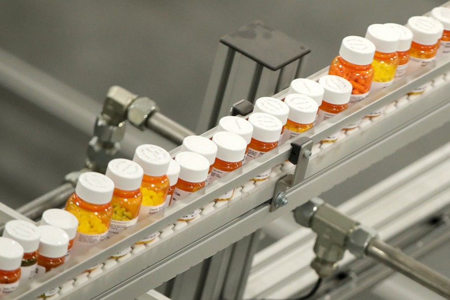 FILE- Bottles of medicine ride on a belt at a mail-in pharmacy warehouse in Florence, N.J., July 10, 2018. The Biden administration says the manufacturers of all of the first 10 prescription drugs it selected for Medicare’s first price negotiations have agreed to participate. Tuesday's announcement clears the way for talks that could lower their costs in coming years and gives the White House a potential political win heading into next year’s presidential election.  (AP Photo/Julio Cortez, File)