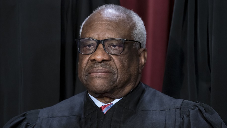 FILE - Associate Justice Clarence Thomas joins other members of the Supreme Court as they pose for a new group portrait, at the Supreme Court building in Washington, Oct. 7, 2022. Thomas said Friday, April 7, that he was not required to disclose the many trips he and his wife took that were paid for by Republican megadonor Harlan Crow. The nonprofit investigative journalism organization ProPublica reported Thursday that Thomas, who has been a justice for more than 31 years, has for more than two decades accepted luxury trips from Crow nearly every year.(AP Photo/J. Scott Applewhite, File)