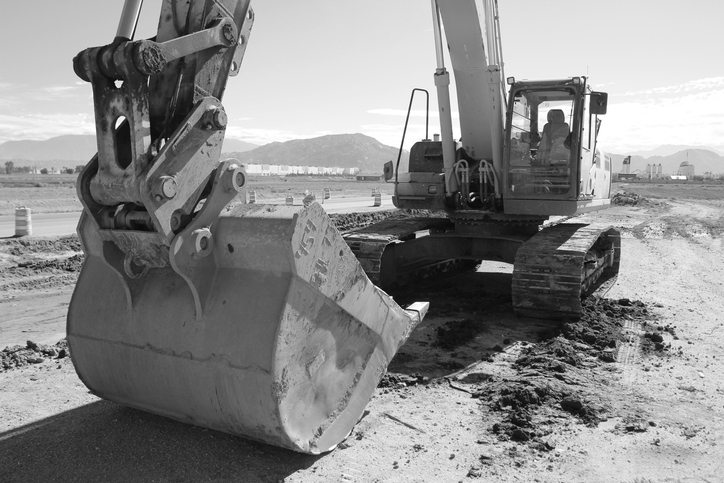 Excavator Parked along Construction Site in Perris California. Black and White Photo.