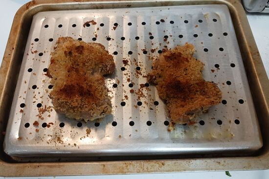 baked chicken cutlets before melting cheese on top