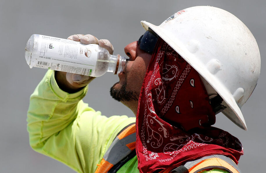 PHOENIX, AZ - JUNE 20:  A Phoenix area construction worker drinks water at a job site on June 20, 2017 in Phoenix, Arizona.  Record temperatures of 118 to 120 degrees were expected on Tuesday for the Phoenix-metro area.  (Photo by Ralph Freso/Getty Images)