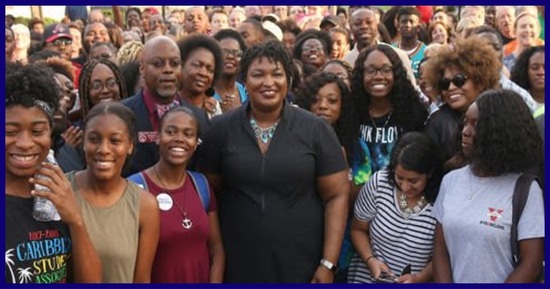 An image of Stacey Abrams surrounded by her supporters.
