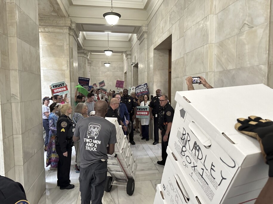 Boxes containing signatures supporting a proposed ballot measure to scale back Arkansas' abortion ban are delivered to a room in the state Capitol in Little Rock, Ark. Friday, July 5, 2024. Organizers submitted petitions to try and get the proposals on the November ballot. (AP Photo/Andrew DeMillo)