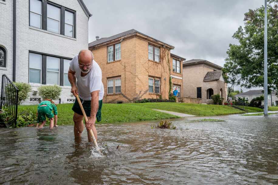HOUSTON, TEXAS - JULY 08: Jack Reyna and his son work to drain floodwater in their neighborhood after Hurricane Beryl swept through the area on July 08, 2024 in Houston, Texas. Tropical Storm Beryl developed into a Category 1 hurricane as it hit the Texas coast late last night. (Photo by Brandon Bell/Getty Images)