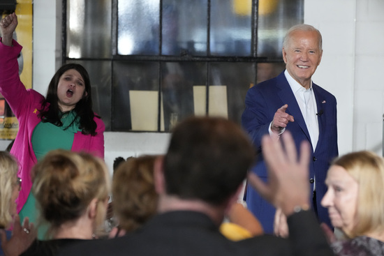 President Joe Biden, right, speaks as Rep. Haley Stevens, D-Mich., left, cheers during a visit to Garage Grill &amp; Fuel Bar during a campaign stop in Northville, Mich., Friday July 12, 2024. (AP Photo/Jacquelyn Martin)