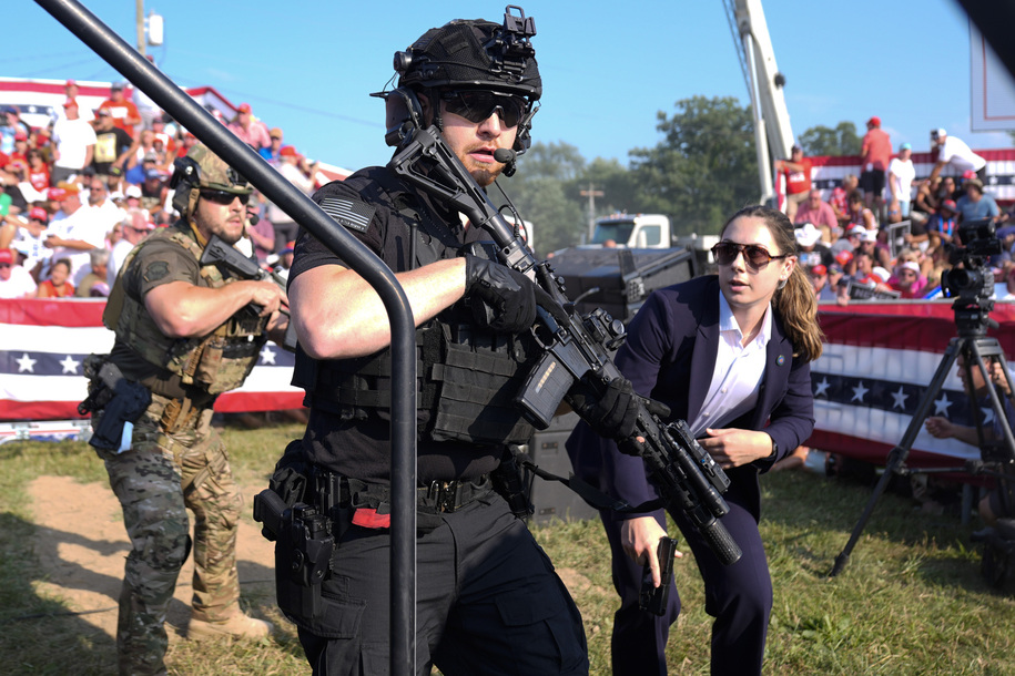 U.S. Secret Service agents respond as Republican presidential candidate former President Donald Trump is surrounded on stage by U.S. Secret Service agents at a campaign rally, Saturday, July 13, 2024, in Butler, Pa. (AP Photo/Evan Vucci)