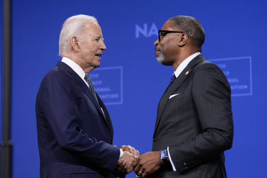 President Joe Biden is welcomed by NAACP President and CEO Derrick Johnson before speaking at the 115th NAACP National Convention in Las Vegas, Tuesday, July 16, 2024. (AP Photo/Susan Walsh)