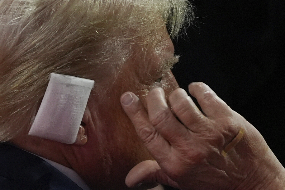 Republican presidential candidate former President Donald Trump points to his ear as he talks to Rep. Jim Jordan, R-Ohio, during the Republican National Convention Tuesday, July 16, 2024, in Milwaukee. (AP Photo/Julia Nikhinson)