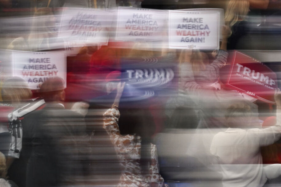 Attendees hold up signs supporting US former President and 2024 Republican presidential candidate Donald Trump during the first day of the 2024 Republican National Convention at the Fiserv Forum in Milwaukee, Wisconsin, July 15, 2024. Days after he survived an assassination attempt, Republicans are set to nominate Donald Trump as the party's official presidential candidate at the Republican National Convention taking place in Milwaukee, Wisconsin, from July 15 to 18. (Photo by ANDREW CABALLERO-REYNOLDS / AFP) (Photo by ANDREW CABALLERO-REYNOLDS/AFP via Getty Images)