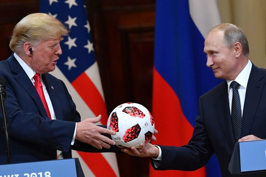 TOPSHOT - Russia's President Vladimir Putin (R) offers a ball of the 2018 football World Cup to US President Donald Trump during a joint press conference after a meeting at the Presidential Palace in Helsinki, on July 16, 2018. - The US and Russian leaders opened an historic summit in Helsinki, with Donald Trump promising an 'extraordinary relationship' and Vladimir Putin saying it was high time to thrash out disputes around the world. (Photo by Yuri KADOBNOV / AFP)        (Photo credit should read YURI KADOBNOV/AFP/Getty Images)